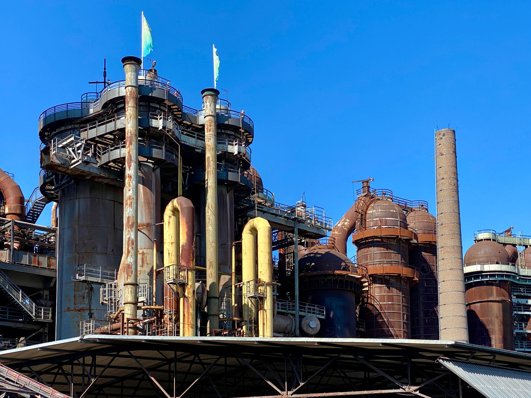 A view of the historic Völklingen Ironworks industrial facility under a clear blue sky.