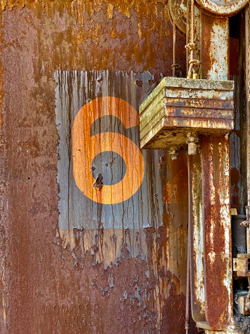 Close-up of Number on Building Wall with Corrosion