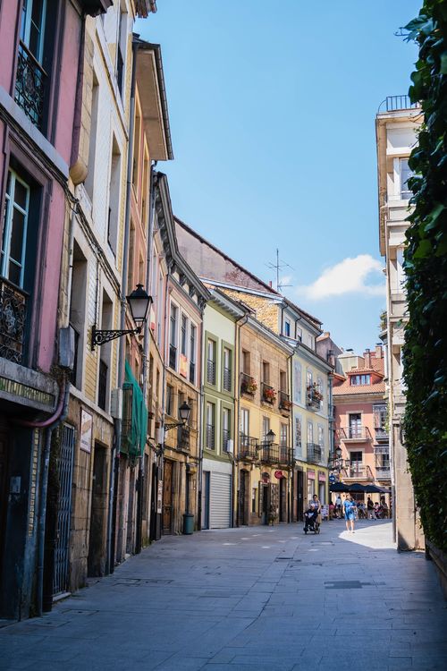 Free Colorful buildings line a quaint street in Oviedo, Spain, under a clear blue sky. Stock Photo