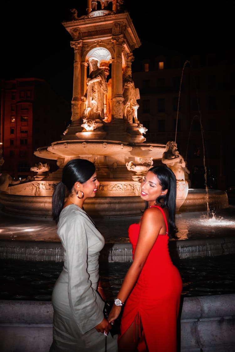 Two Women In Red And Gray Dresses