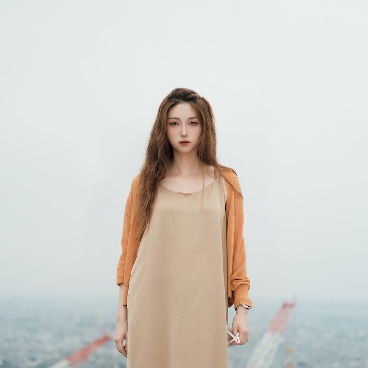 Woman With Long Hair In A Dress And A Cardigan