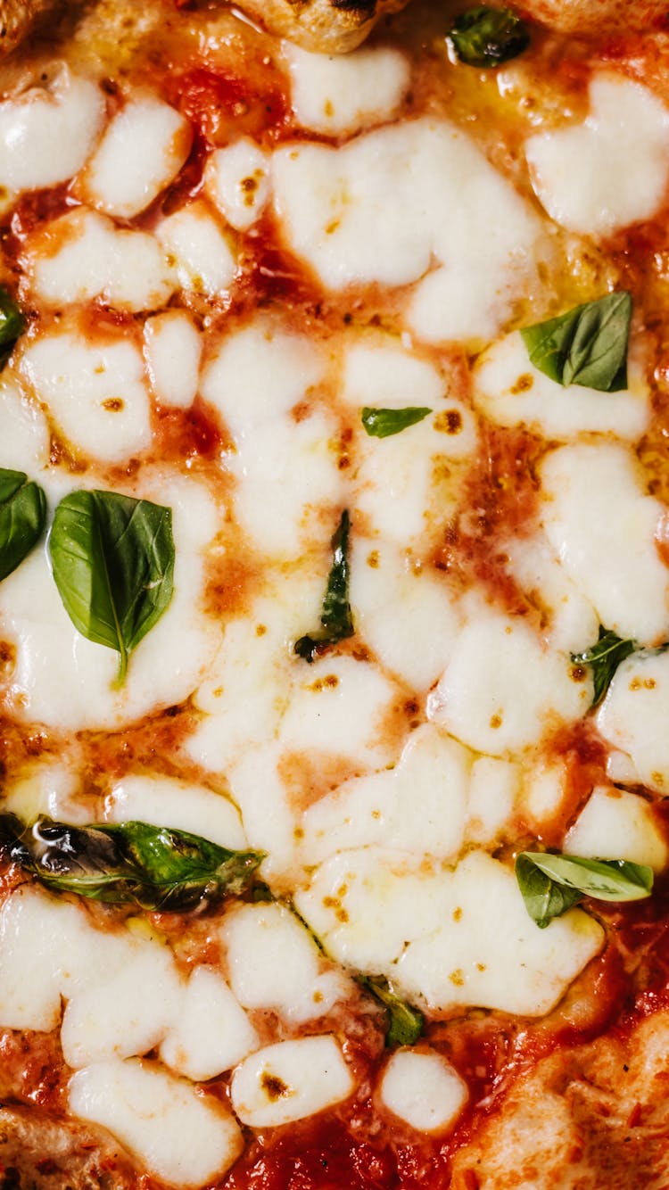 Close-Up Shot Of Cheese On A Pizza