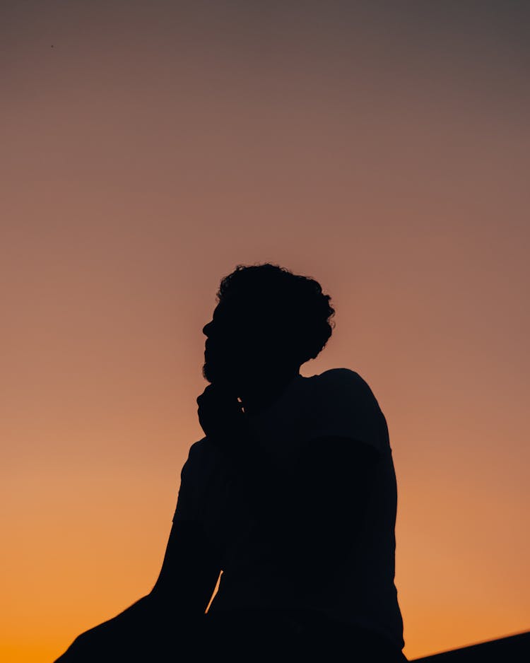 Silhouette Of A Person Sitting 