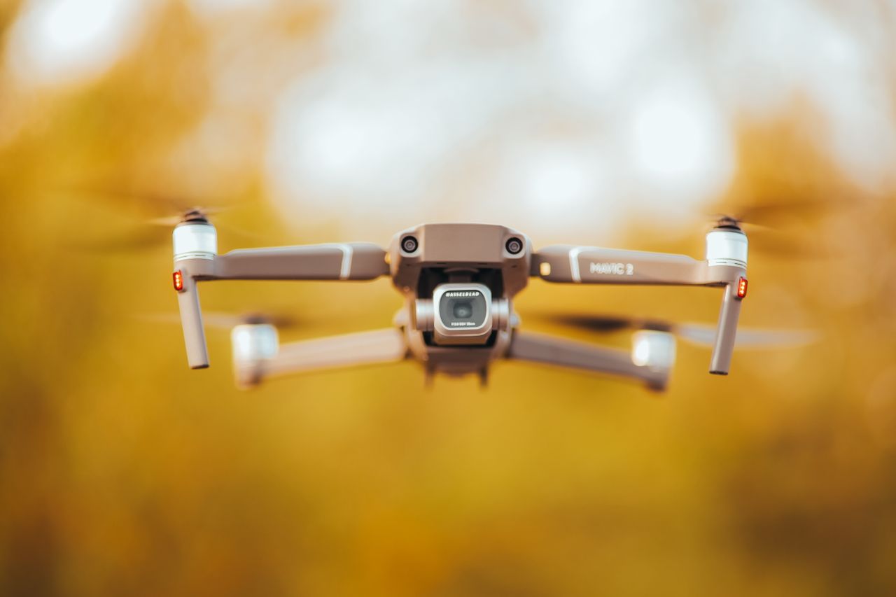 high quality close up of a camera drone in flight with a soft golden b