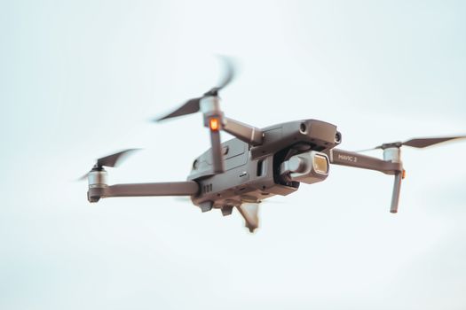A close-up image of a sleek drone in flight showcasing its modern design and precision technology.