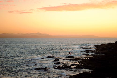 Angler Fishing on Rocky Shore