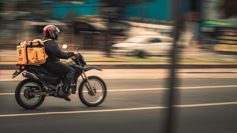 A delivery driver picking up an order from a restaurant