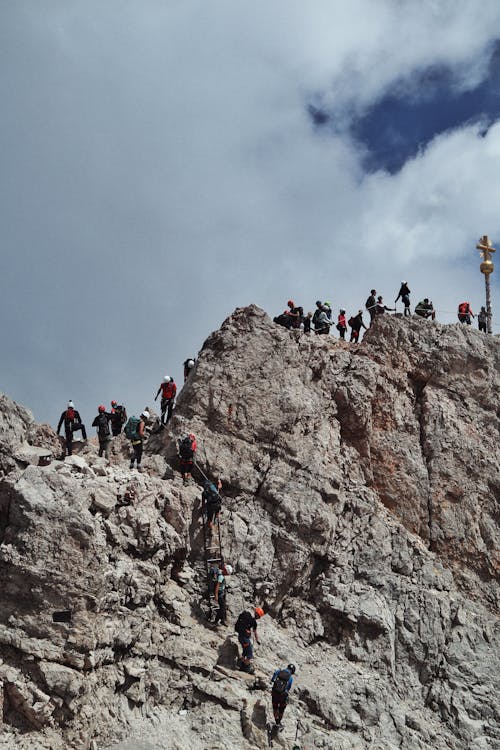 People Climbing on Mountain