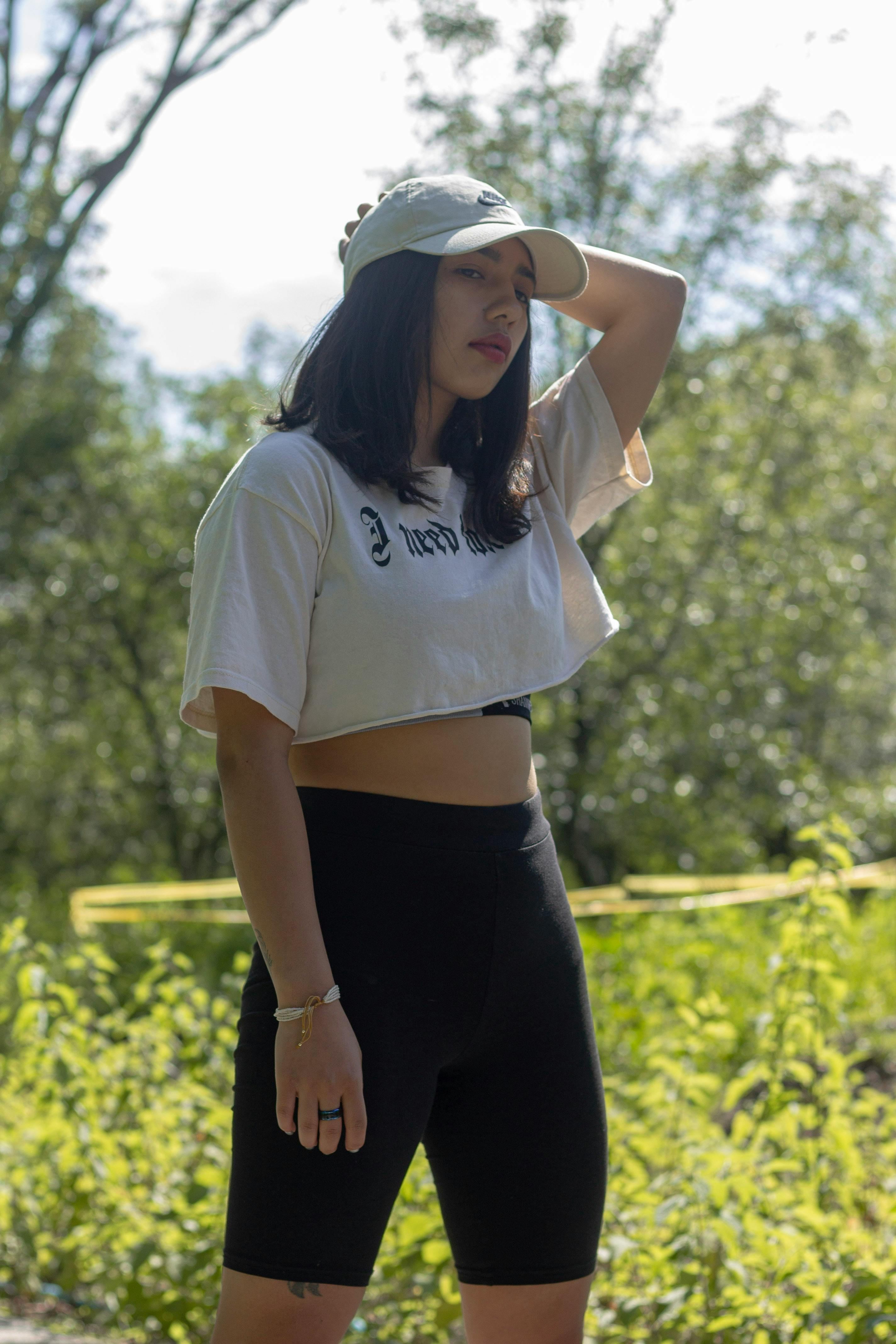 A Woman Wearing a White Crop Top and Shorts · Free Stock Photo