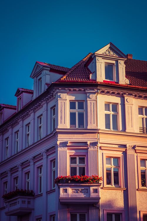 Free Elegant historic building facade in Słupsk, Poland with classic architectural details and bright blue sky. Stock Photo