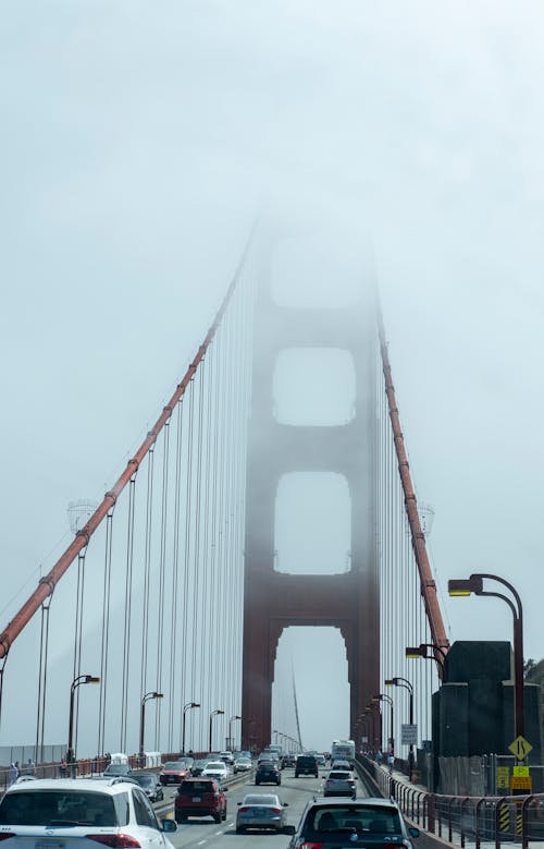 Vehicles on Golden Gate Bridge Under White Sky