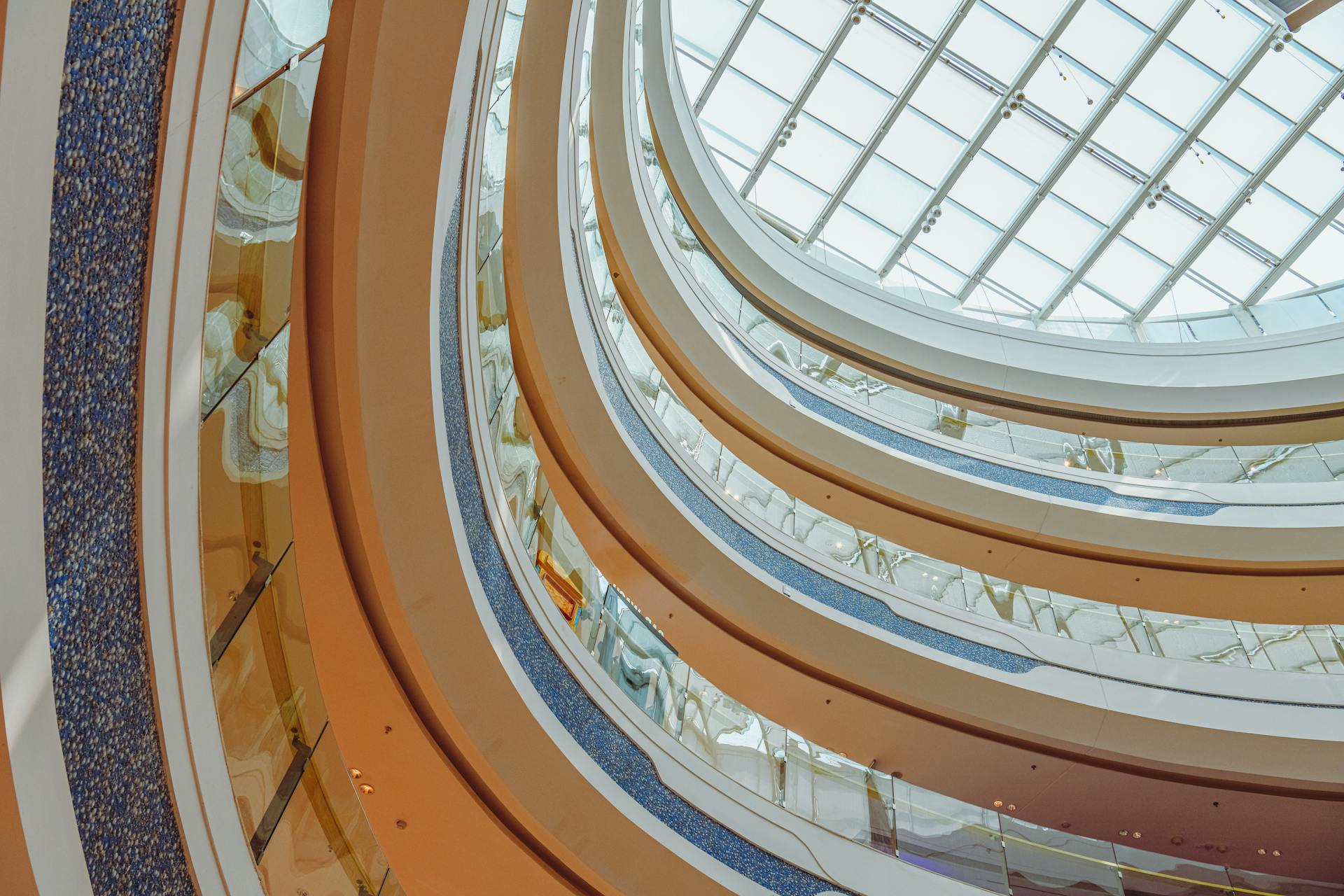 Elegant view of a shopping mall's balconies and glass skylight showcasing modern architecture.