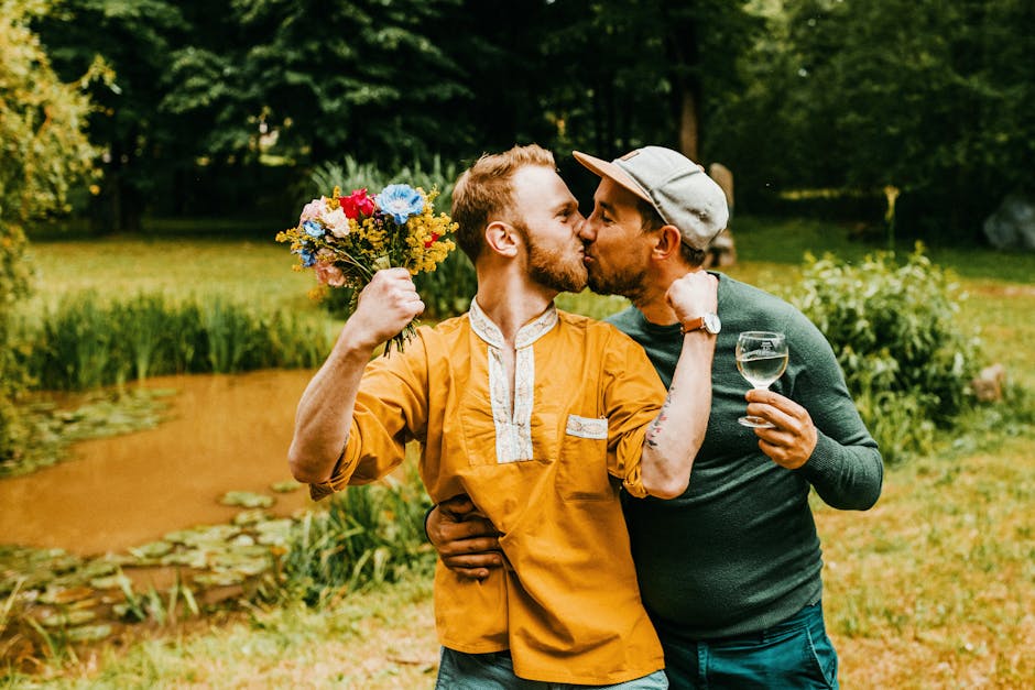 A happy couple shares a romantic kiss by a serene pond in a lush garden setting.