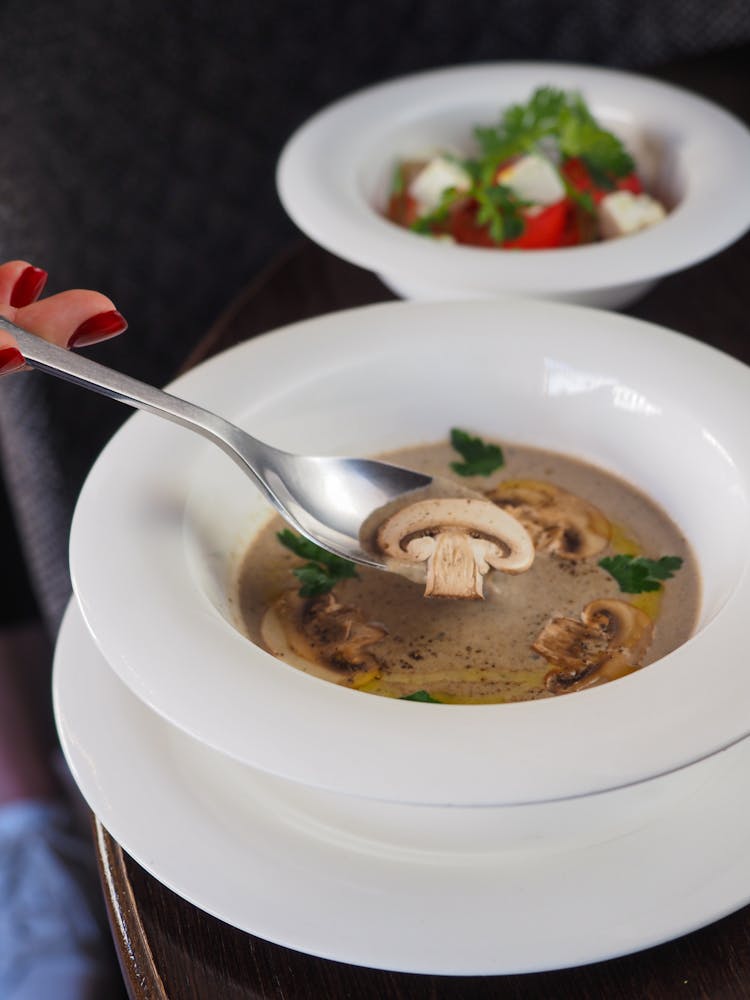 Close-up Of Woman Eating Champignon Soup 