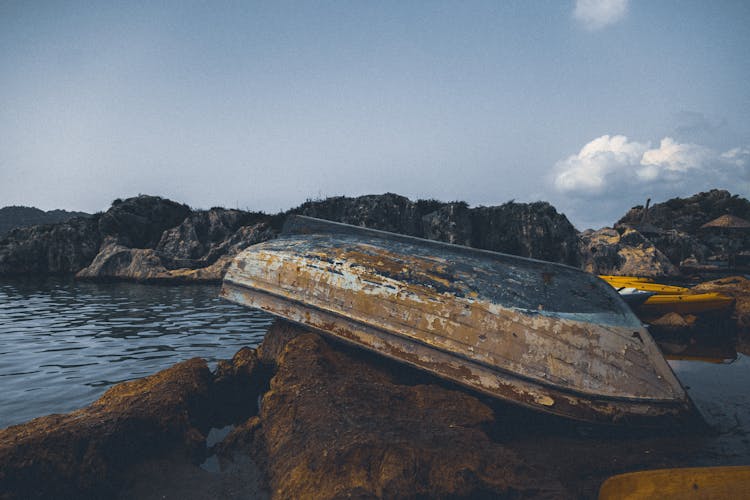 Old Boat On A Rock Near Sea 