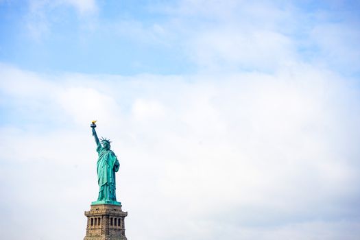 A stunning view of the Statue of Liberty with a clear blue sky, symbolizing freedom and welcome.