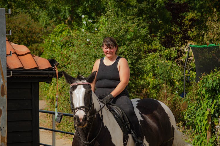 Smiling Woman Riding Horse