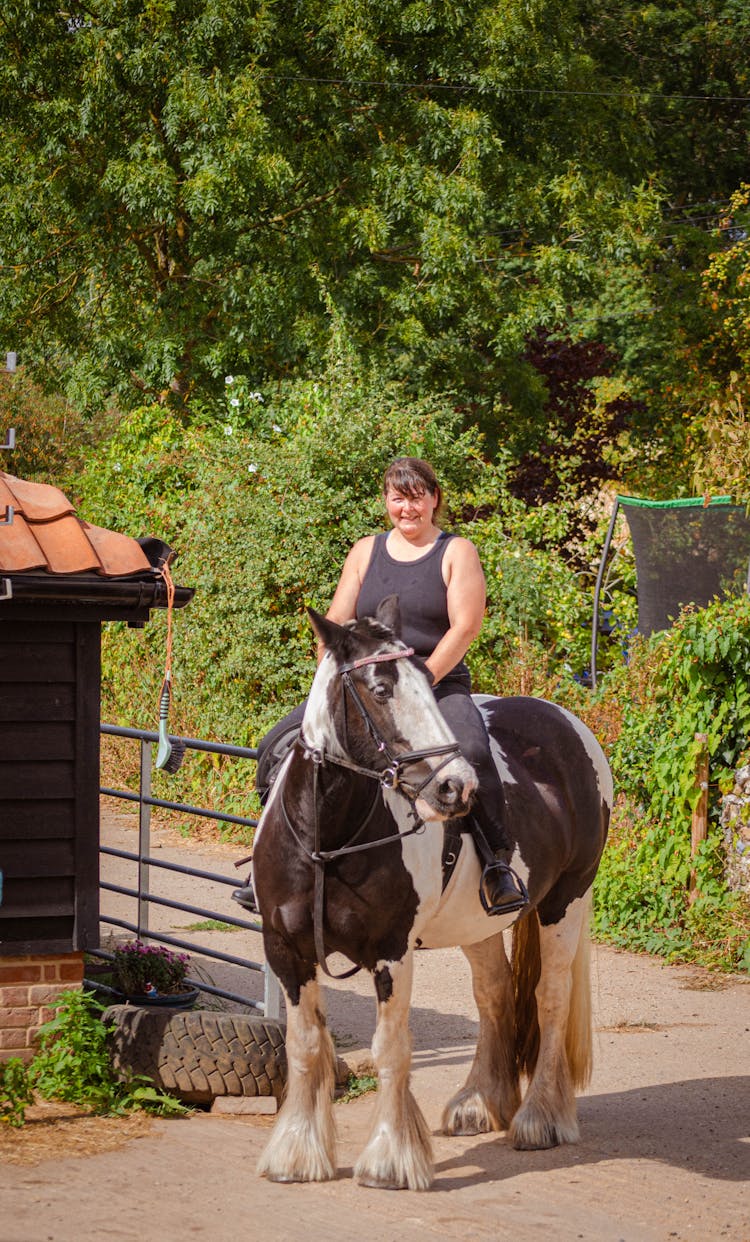 Woman Riding Horse In Countryside