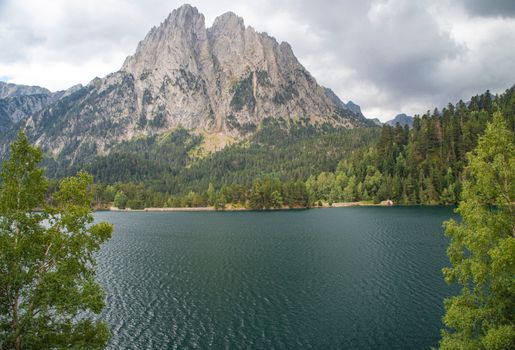Beautiful landscape of Estany de Sant Maurici with Gran Encantat in the background, Catalonia, Spain.