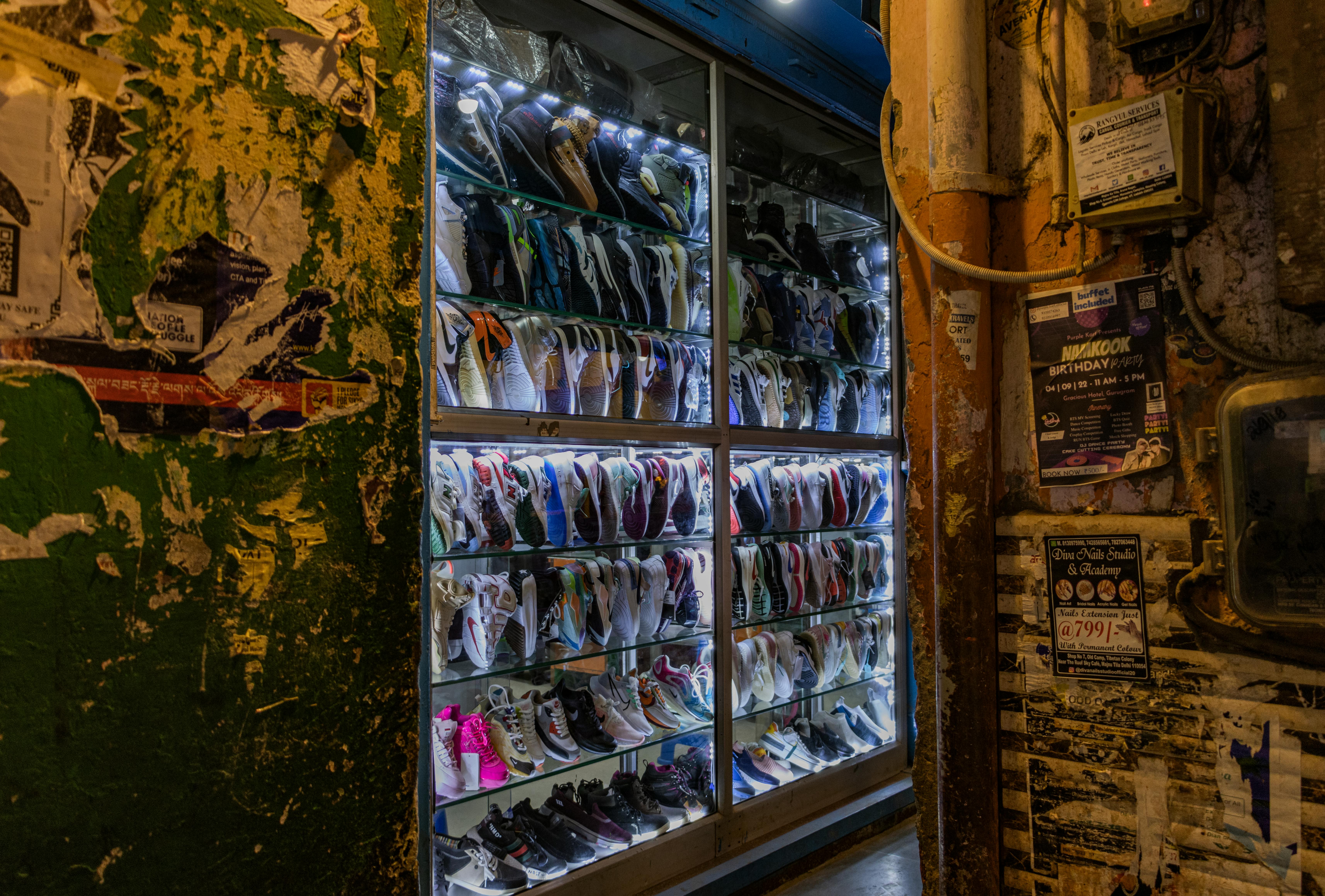 Retail store owner selecting and arranging shoe displays