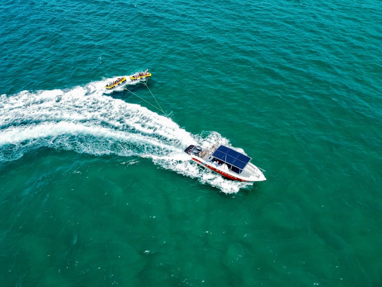 A Motorboat Tugging Rubber Boats 