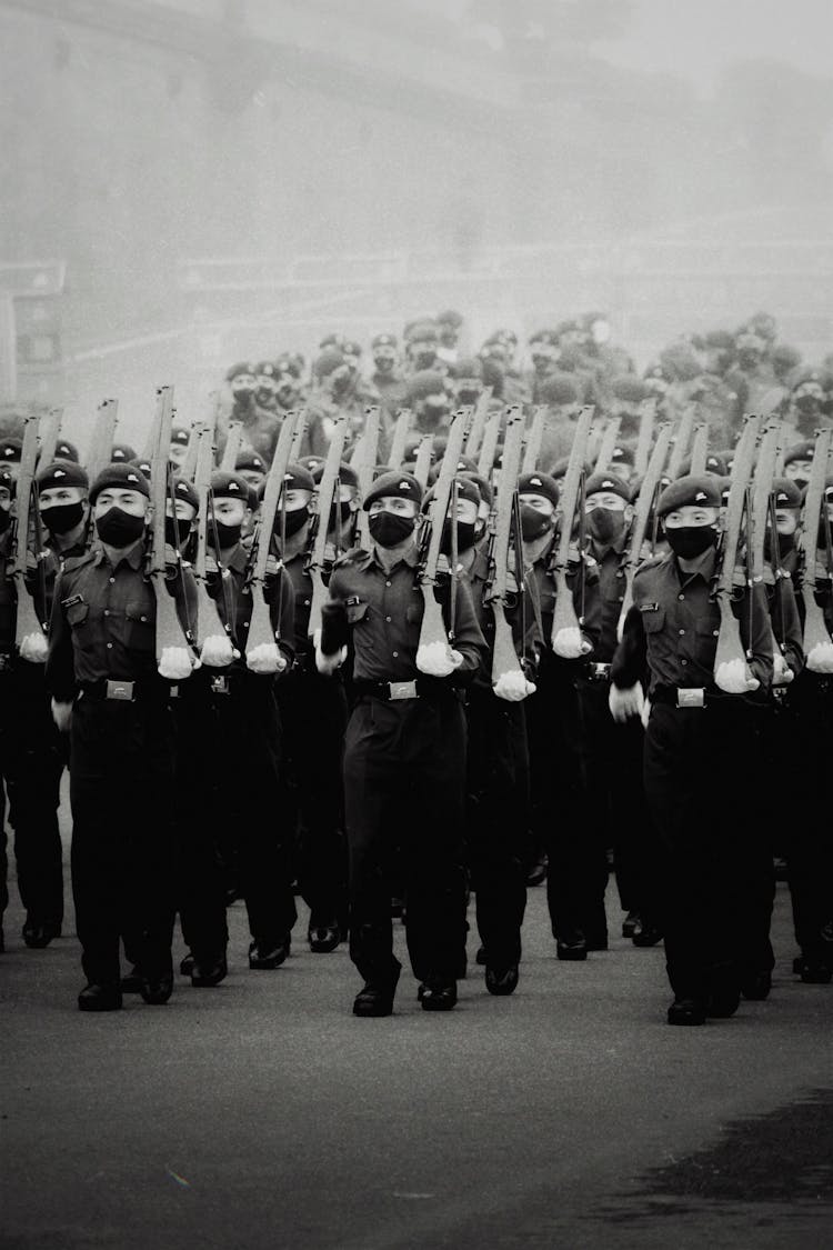 Grayscale Photo Of Marching Soldiers