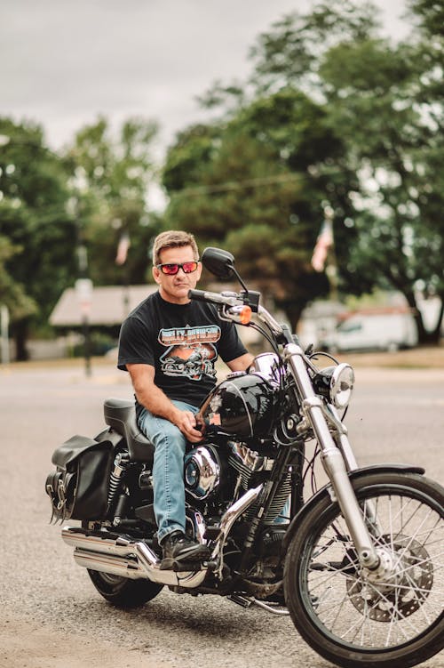 Free Man in Sunglasses Sitting on a Motorcycle Stock Photo