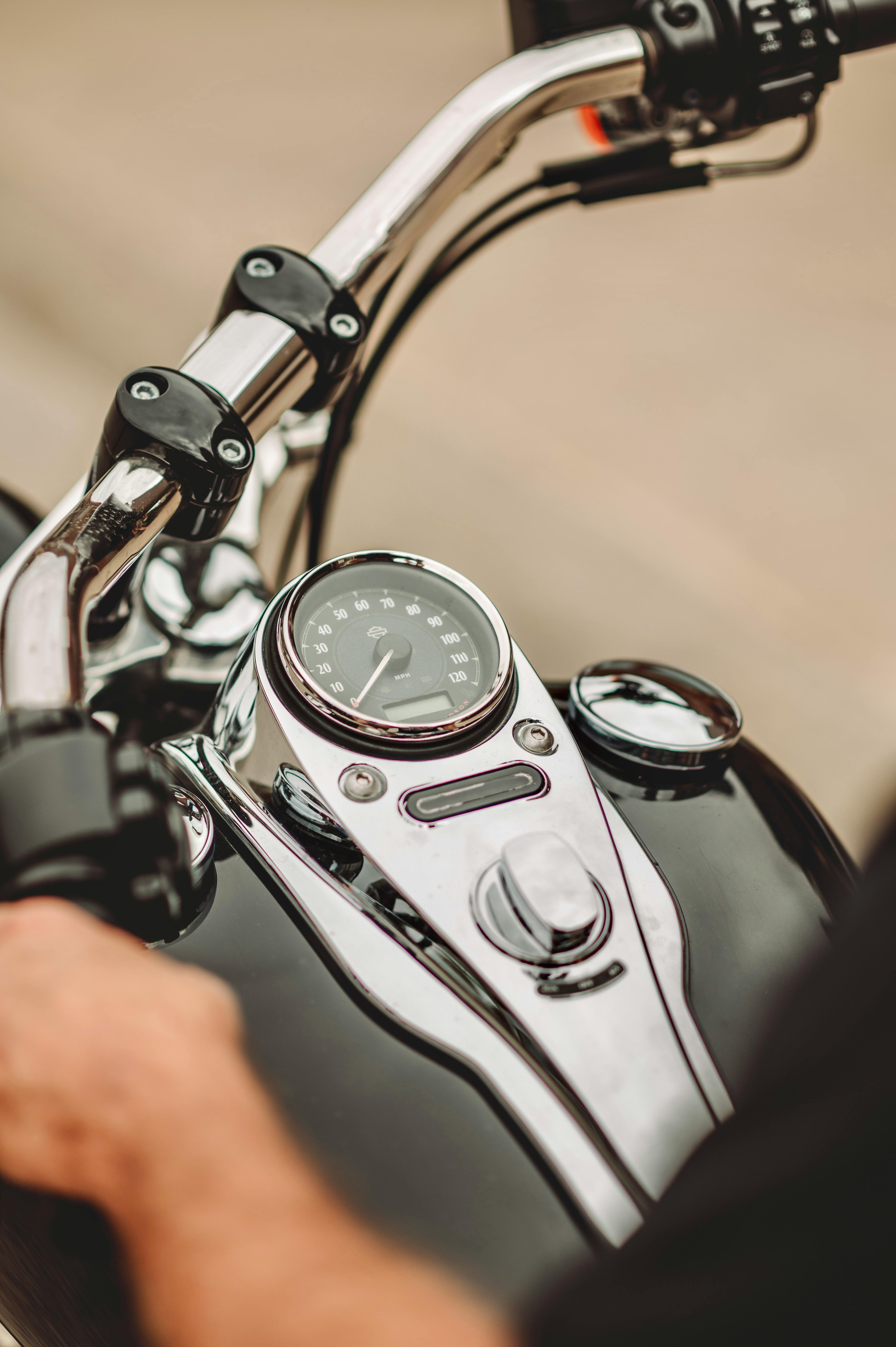 clock and the handlebars of a motorcycle