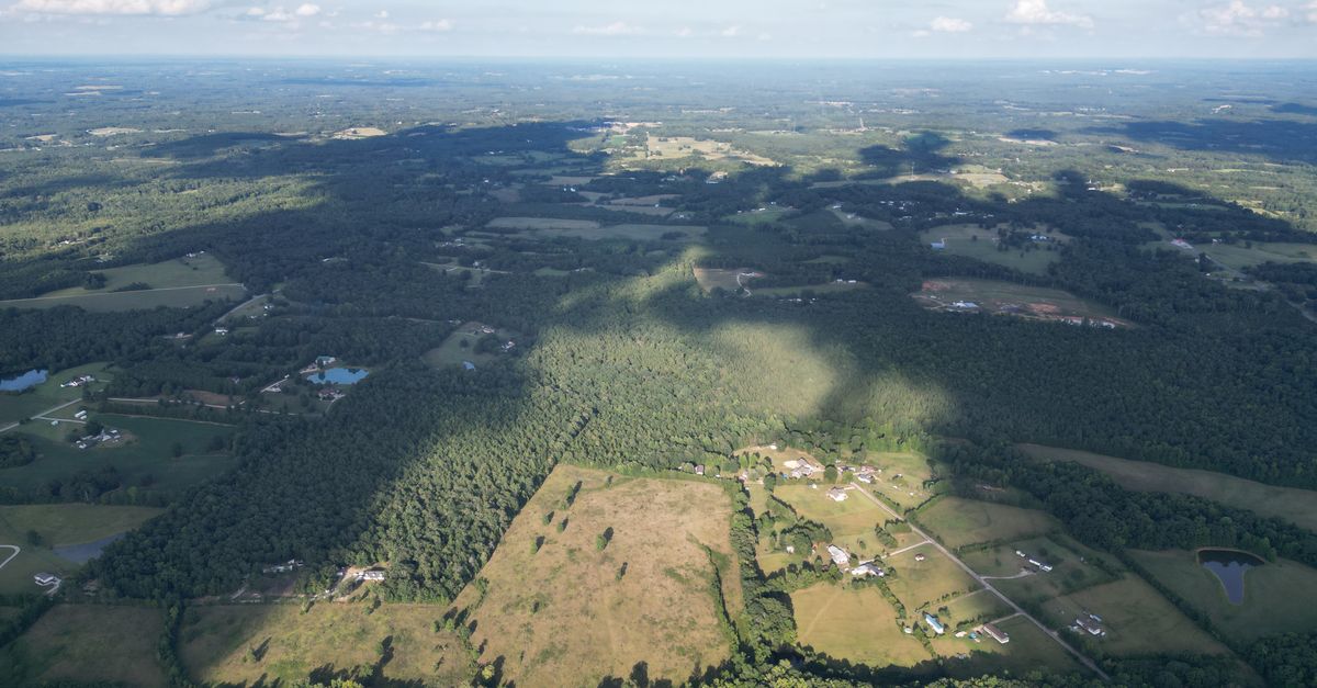 Explore the expansive natural landscape of Lancaster, SC, from above, showcasing fields, forests, and rural charm.