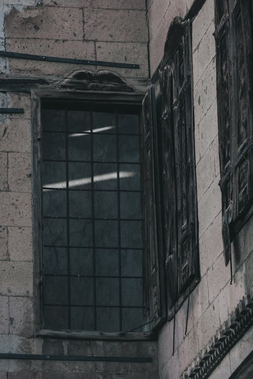 Glass Window of Gray Concrete Building