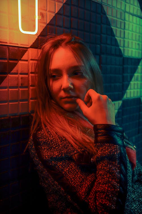 Woman in Black Jacket Leaning on a Wall