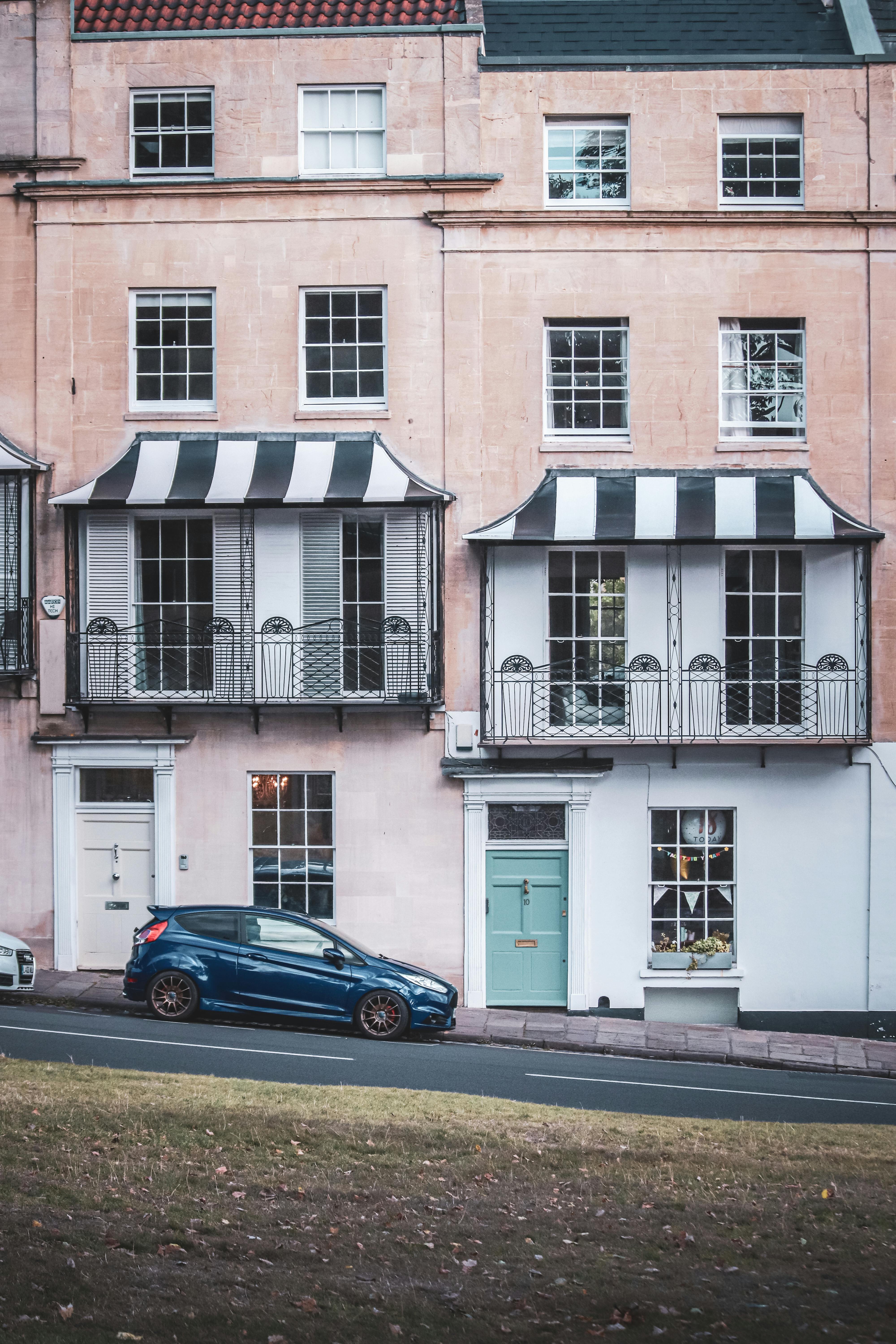 Elegant townhouses with striped awnings in Bristol, England.