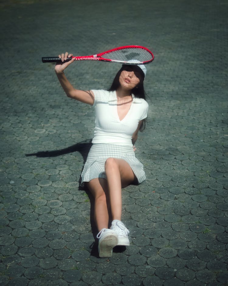 A Woman Holding A Racket