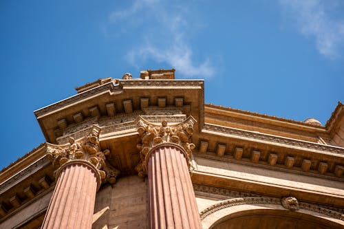 Low Angle Photography of Beige Concrete Building Under Blue Sky