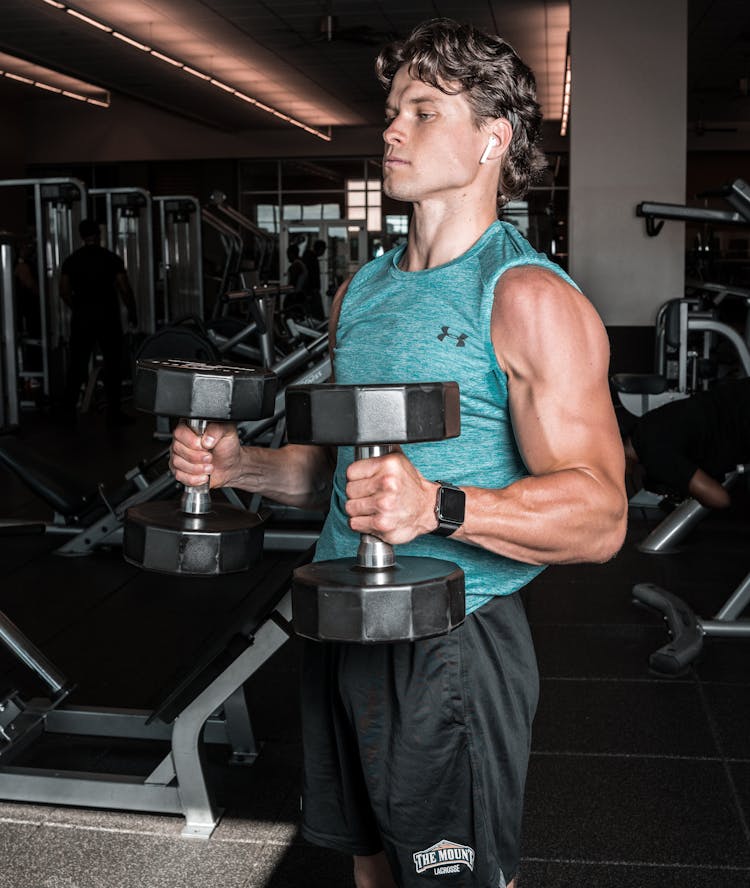 Man Carrying Dumbbells At A Gym