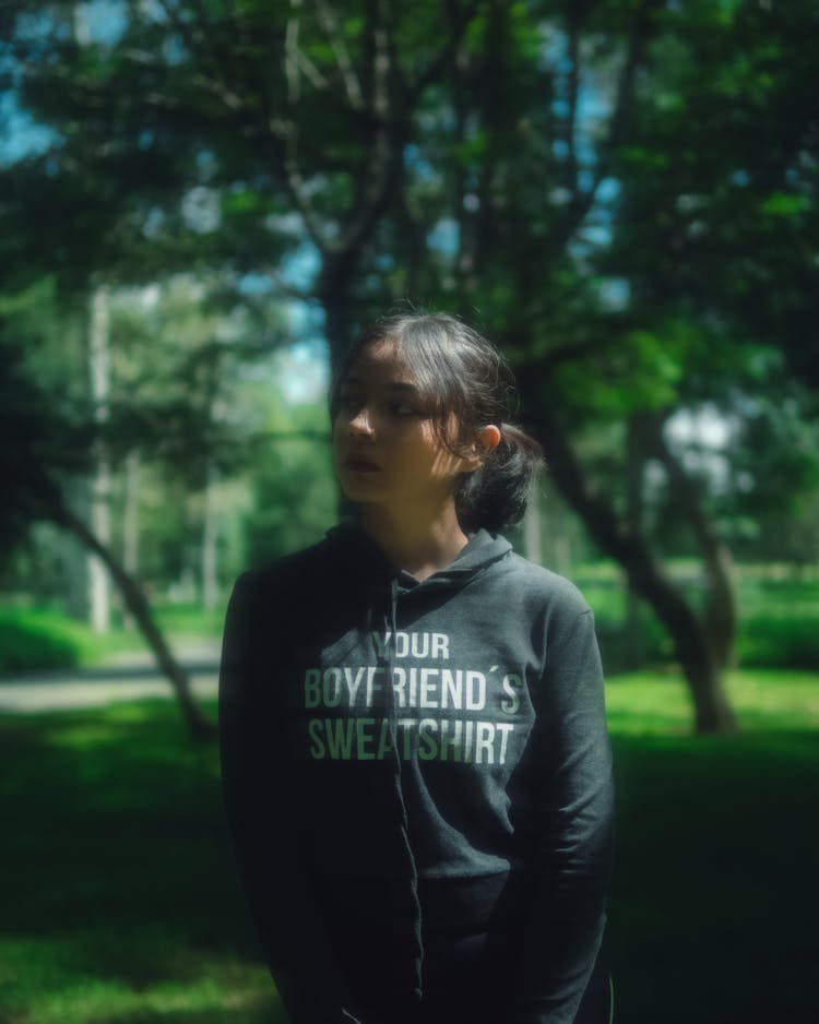 A Young Woman In Black Hoodie Sweater