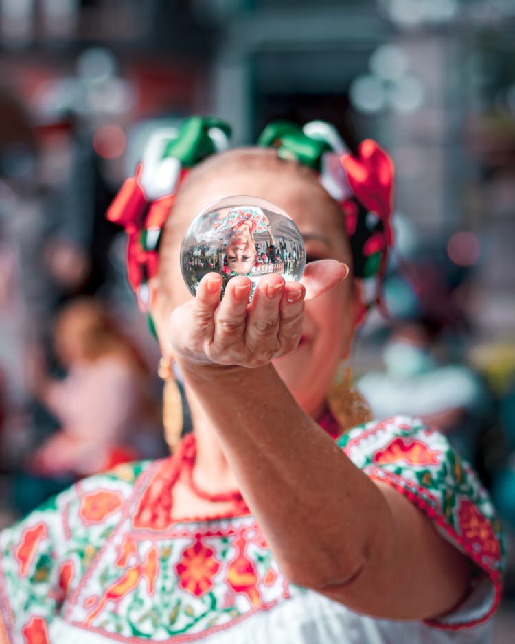 A Woman Holding A Crystal Ball