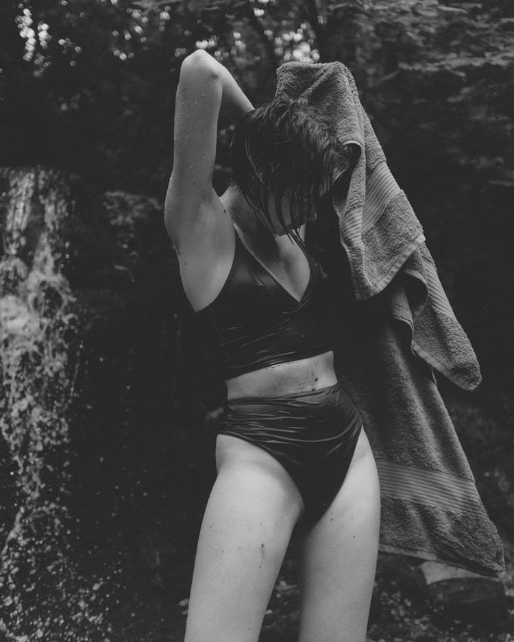 Woman In Bathing Suit Holding A Towel