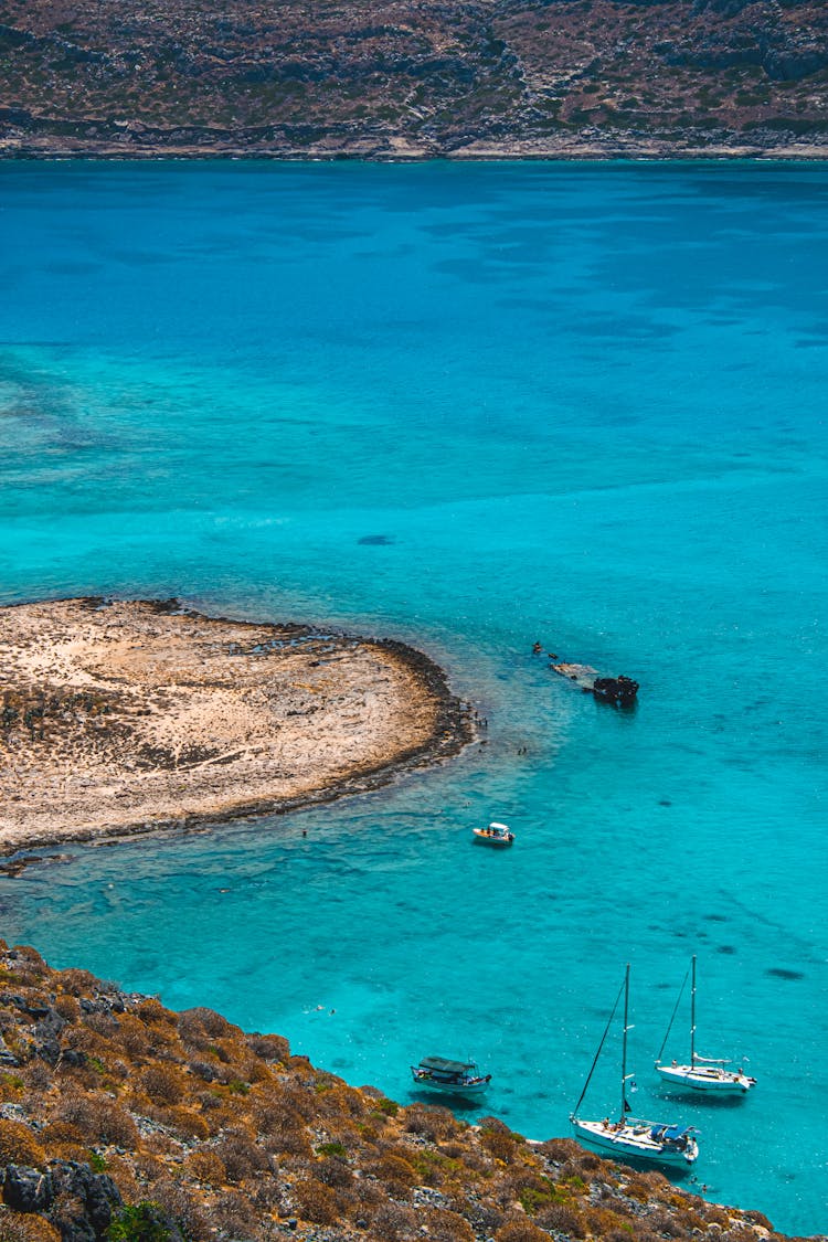 Boats On Blue Water Near A Shoreline