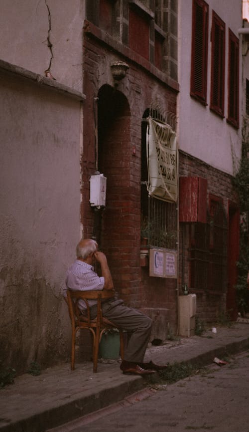 Man Sitting on a Wooden Chair 