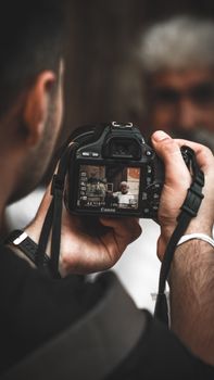 Photographer capturing a portrait using a DSLR camera outdoors.