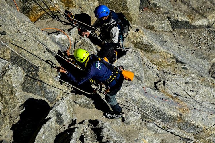 Photo Of Two People Climbing A Mountain 