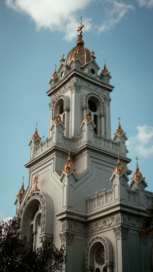 Free St. Stephen's Orthodox Church tower with intricate baroque architecture under a clear blue sky in Istanbul. Stock Photo