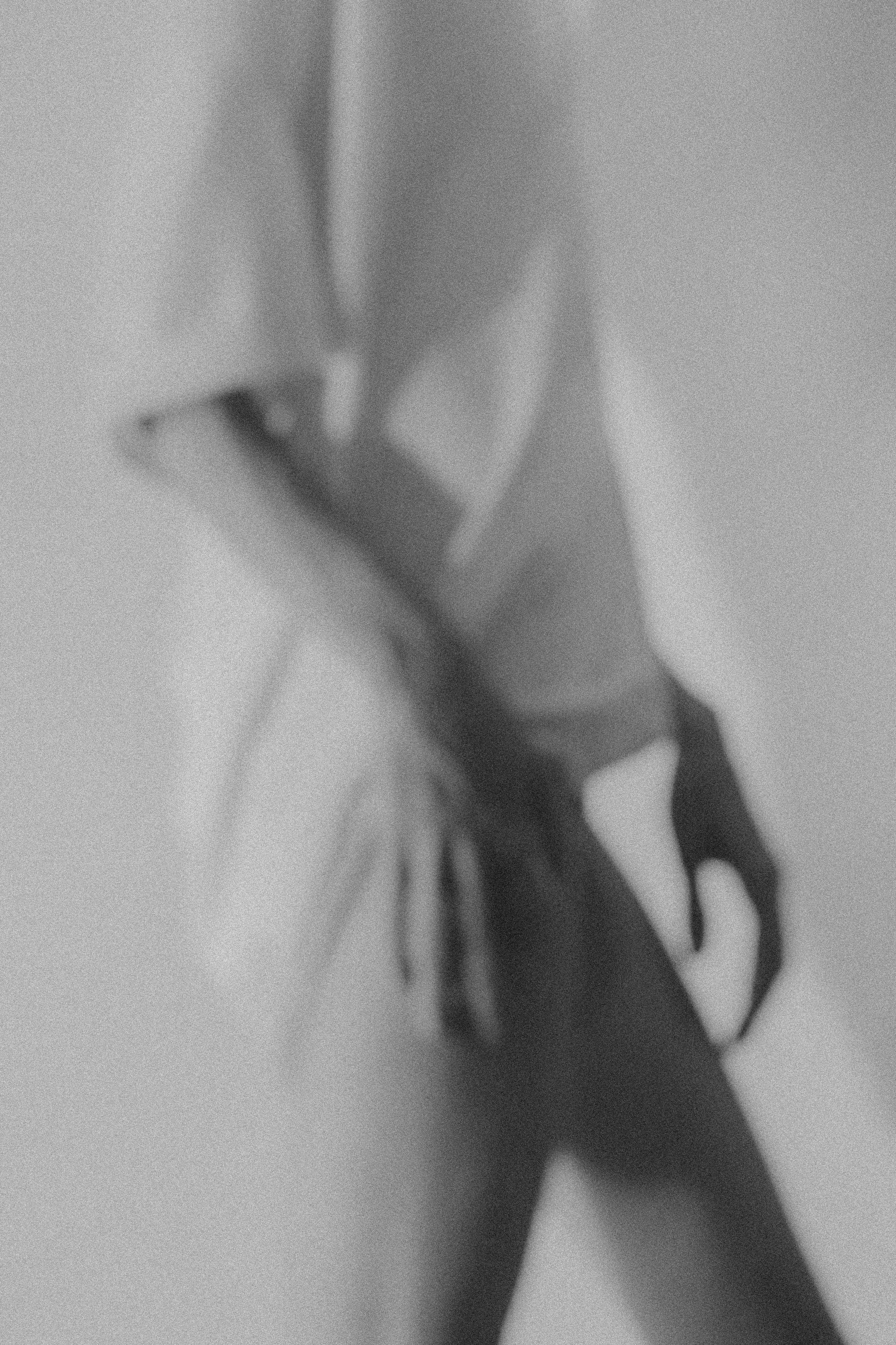 Blurred silhouette of a person in black and white, creating an abstract and artistic feel.