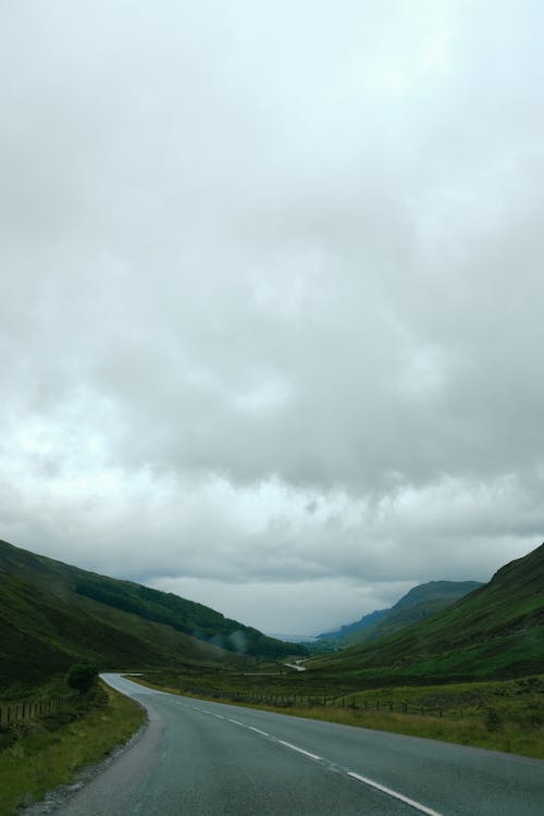 Green Mountains Along an Empty Road