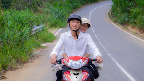 Woman Embracing Man Driving Motorcycle