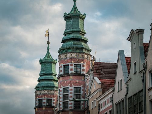 Free A close-up view of the baroque towers of The Great Armoury in Gdansk, Poland against a cloudy sky. Stock Photo
