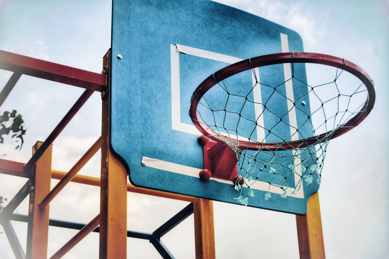 Basketball player changing direction on an indoor court while wearing athletic gear