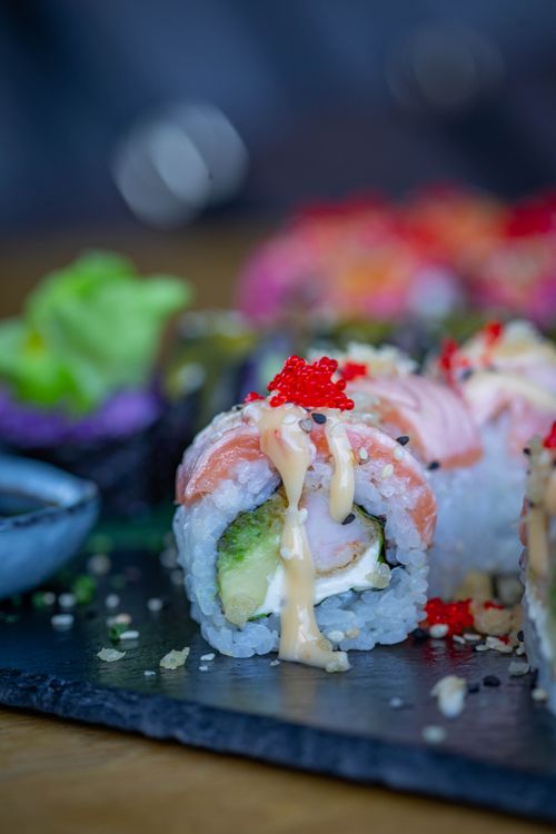 Free Delicious gourmet sushi roll with fresh ingredients served on a slate plate. Stock Photo