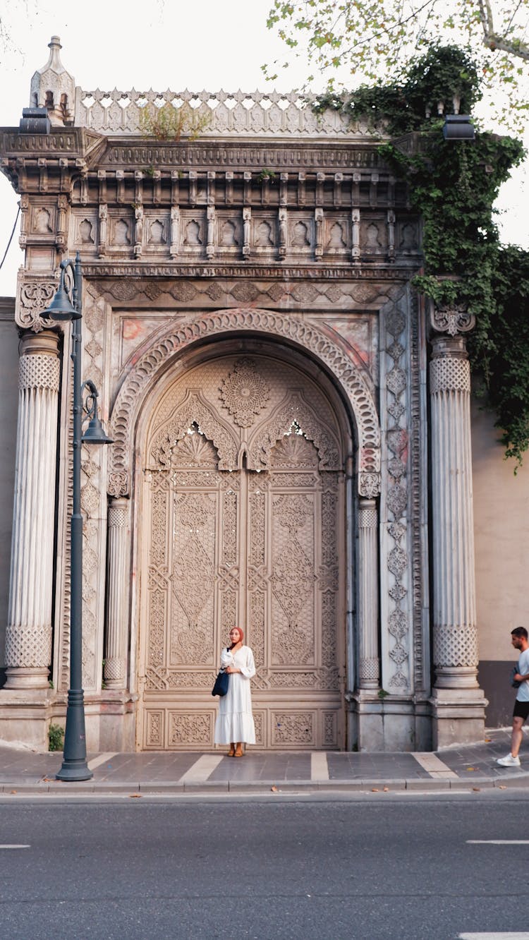 Woman Standing Near Traditional Building On Street